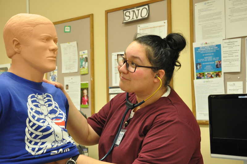 student with nursing mannequin