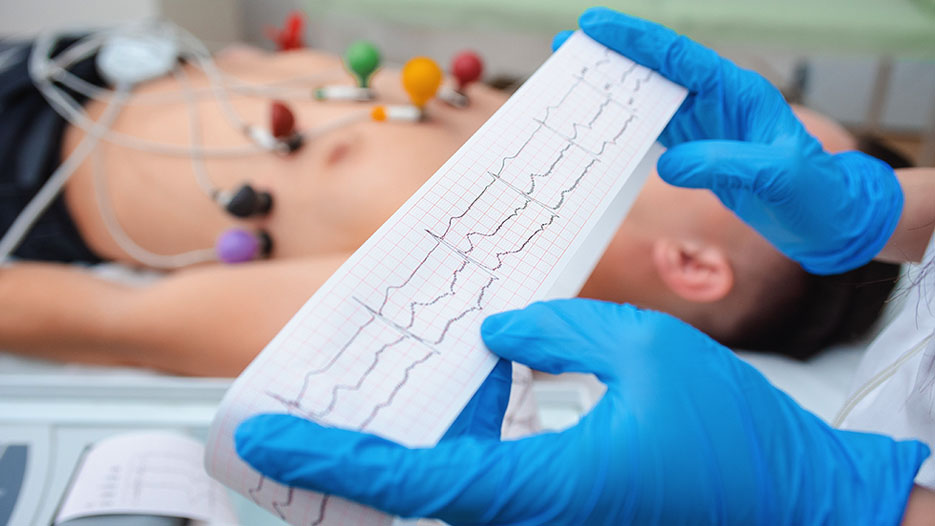 hands holding EKG graph