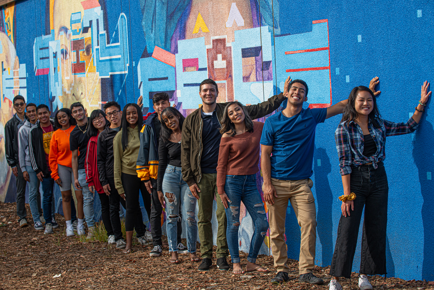 students lined up alongside Justice mural