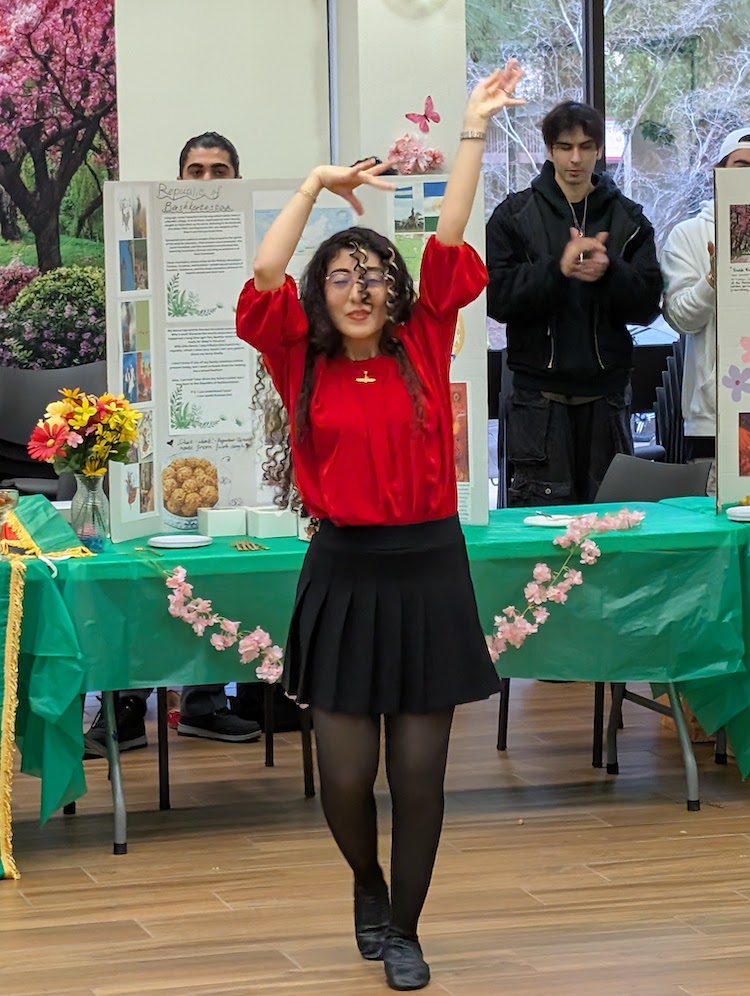 young woman in red with arms up