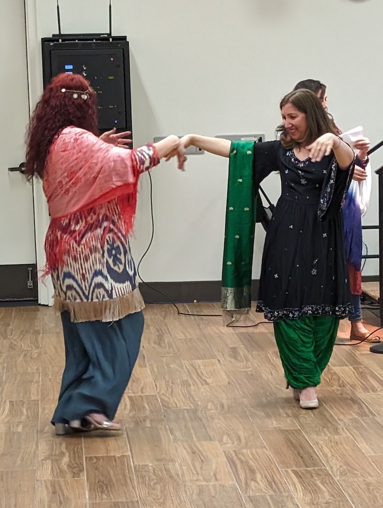 two women dancing in traditional dress