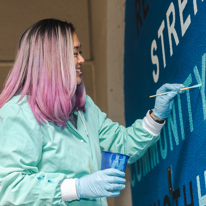 student painting mural