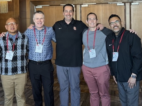 people lined up with arms on shoulders