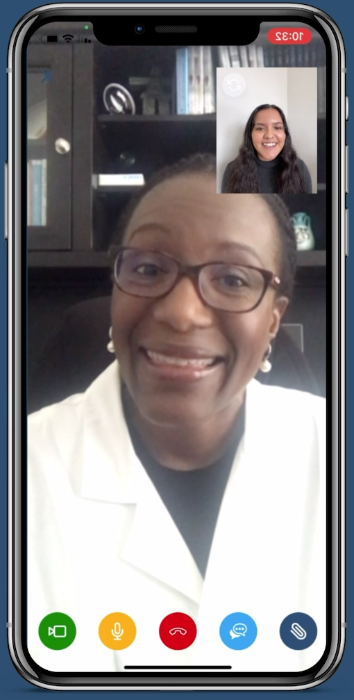 woman in white coat speaking on video call with young woman in dark sweater