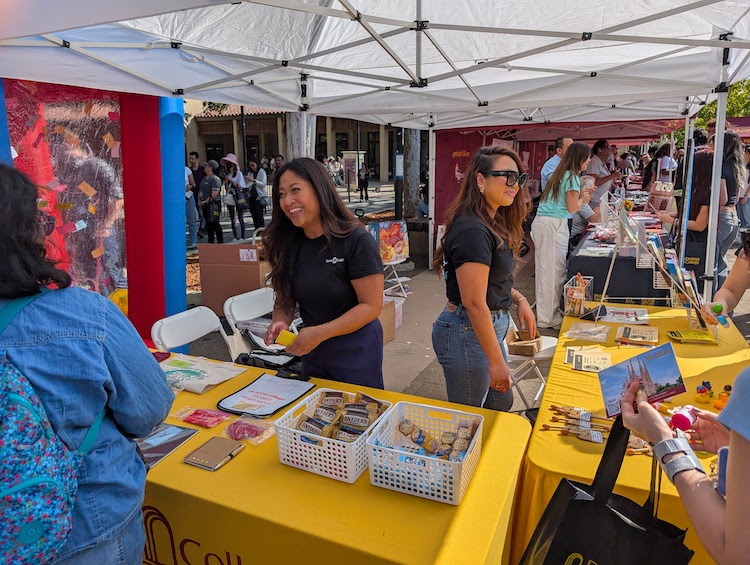 woman at table helping student