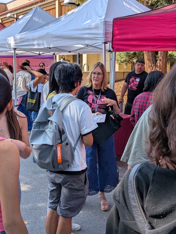 students talking by tables